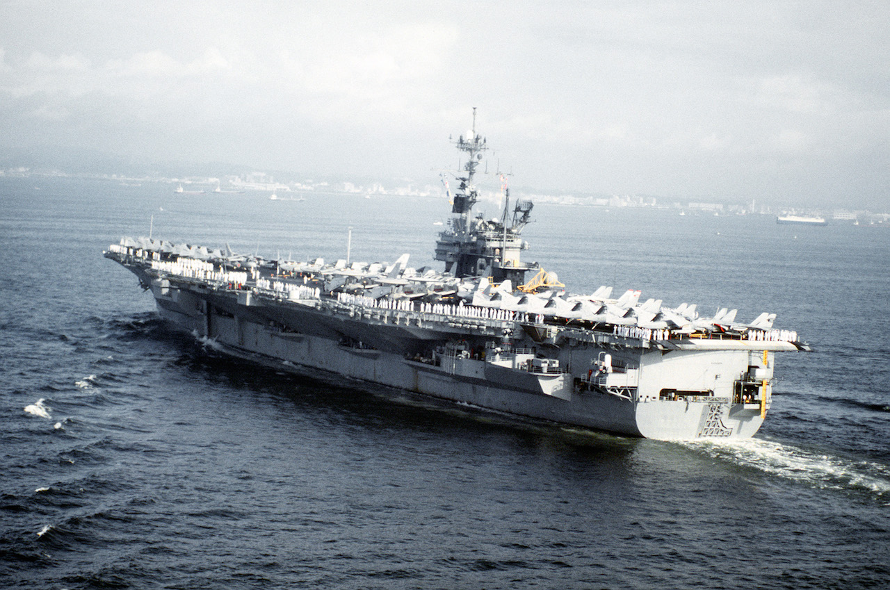 A port quarter view of the aircraft carrier USS RANGER (CV-61) approaching port at Yokosuka on its last visit to Japan. The RANGER is on its final deployment prior to decommissioning.